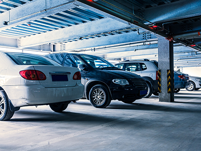 Cars parked side by side in a parking garage