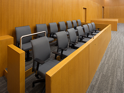 Empty Jury box in a courtroom.