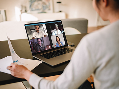 Back view of a person on a video conference with four other people.