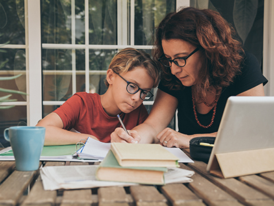 Mother helps her child with at home learning