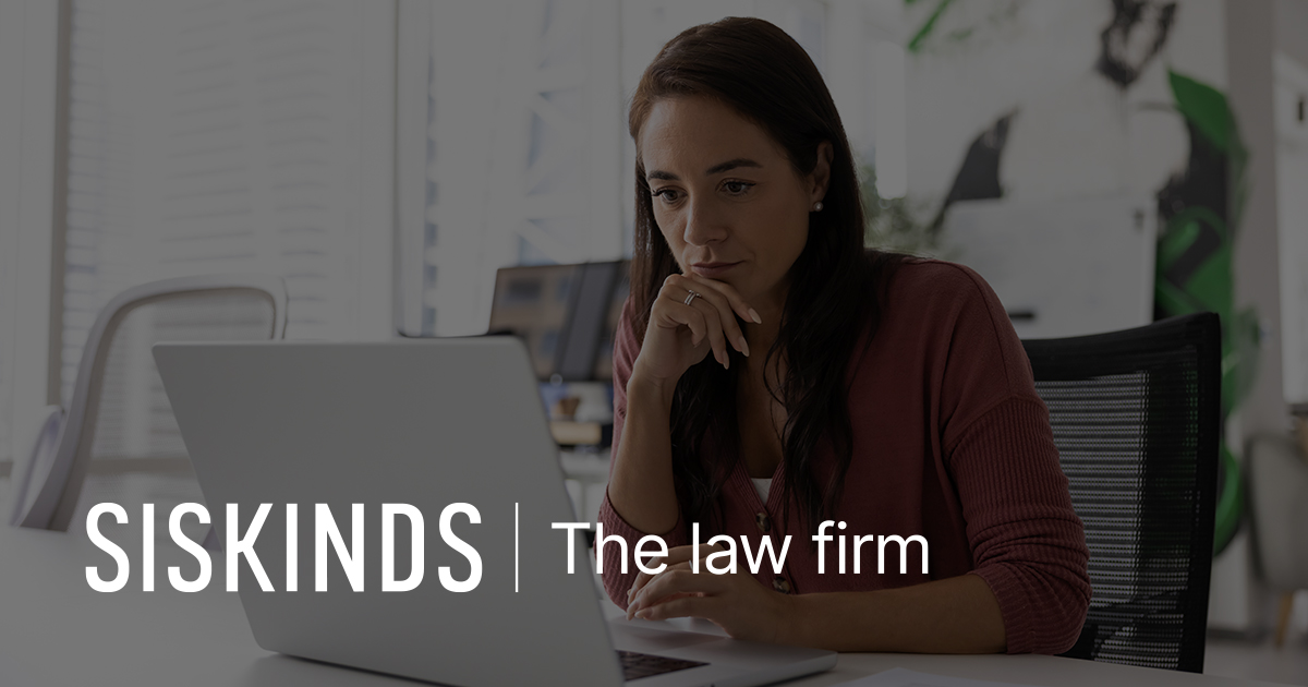 Image of a woman looking at a laptop with Siskinds LLP logo in bottom left corner.