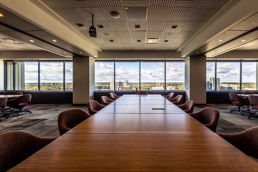 Three board rooms with temporary walls removed to reveal an extra large open space with three large board tables.