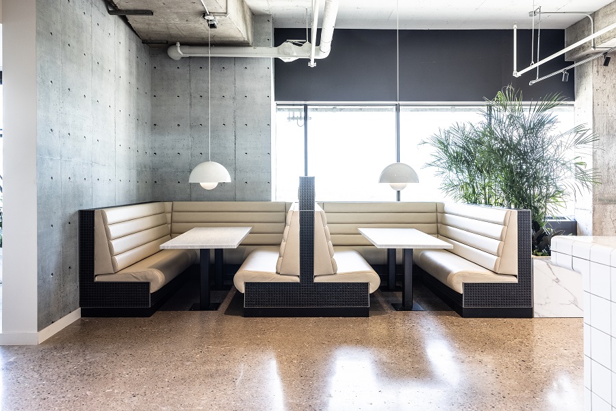 Two large white cloth booths with tables in The Plaza - Siskinds' lunch area.