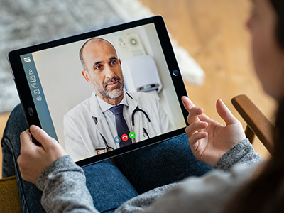 Person video calling a doctor on an iPad